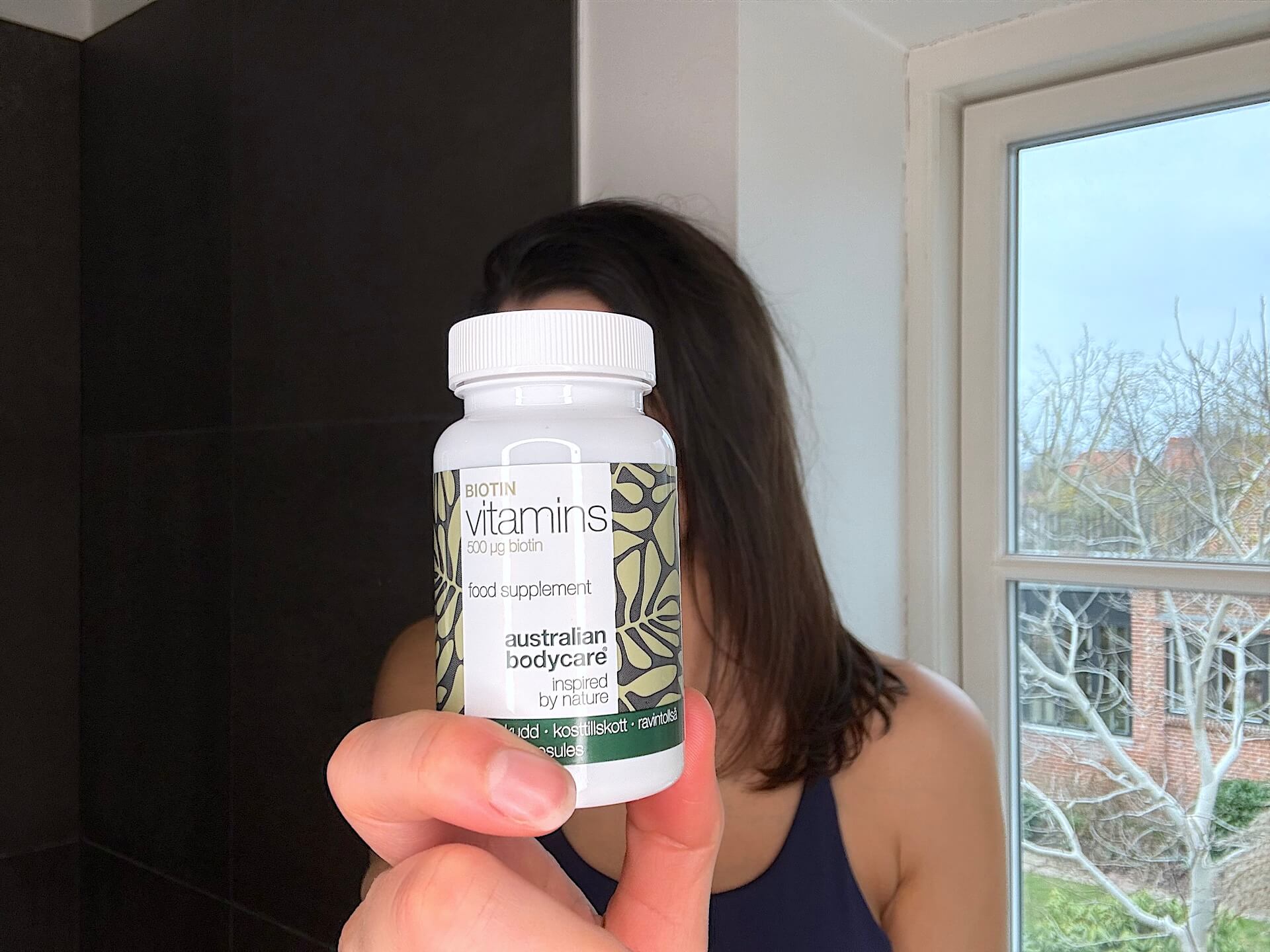 Australian Bodycare Biotin Vitamins holdes af kvinde