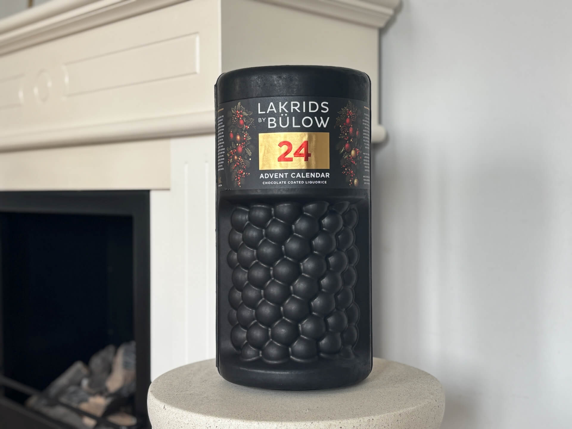 Bülow Lakrids julekalender foran pejs i stue