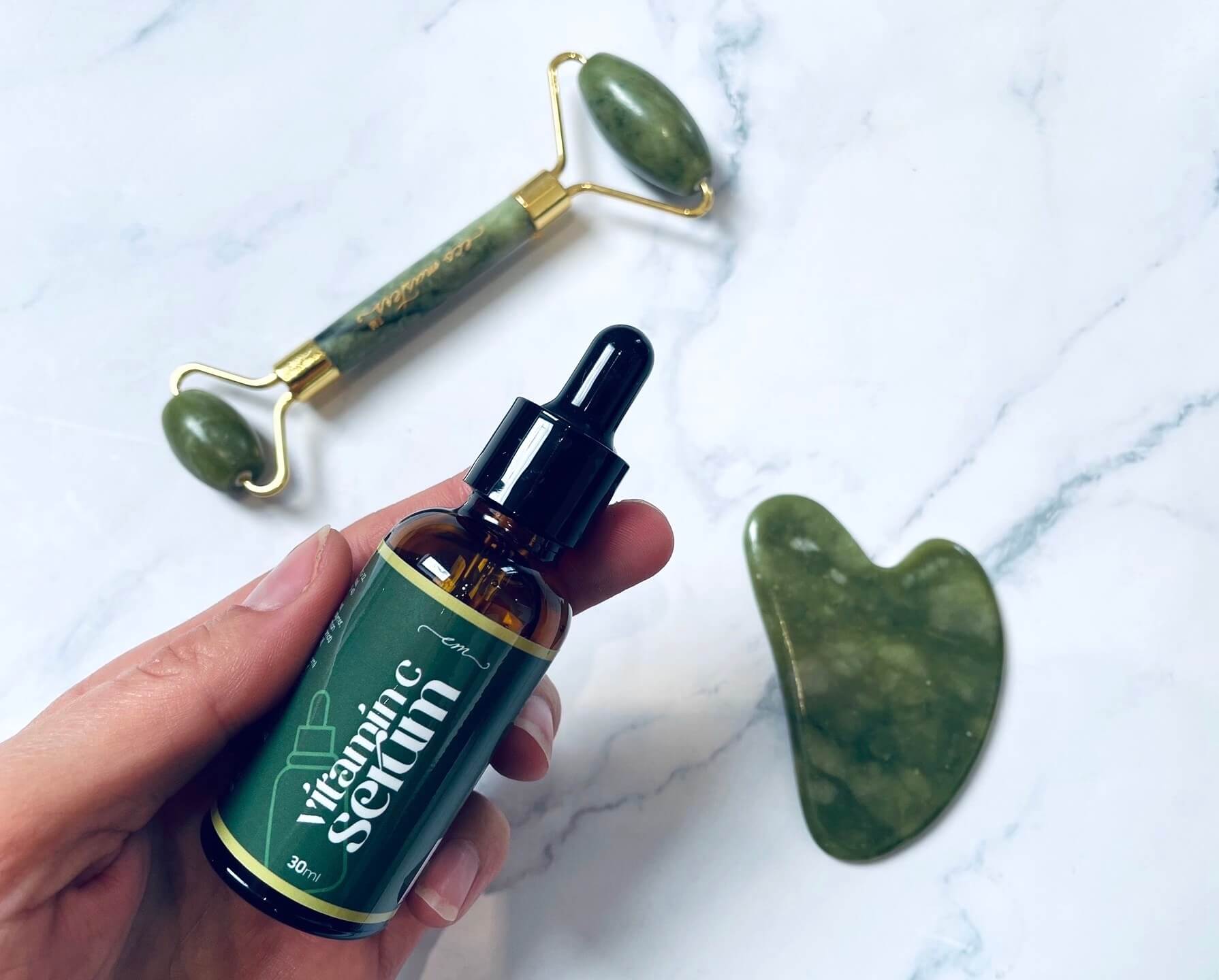 Eco Masters gua sha sæt med serum i hånden