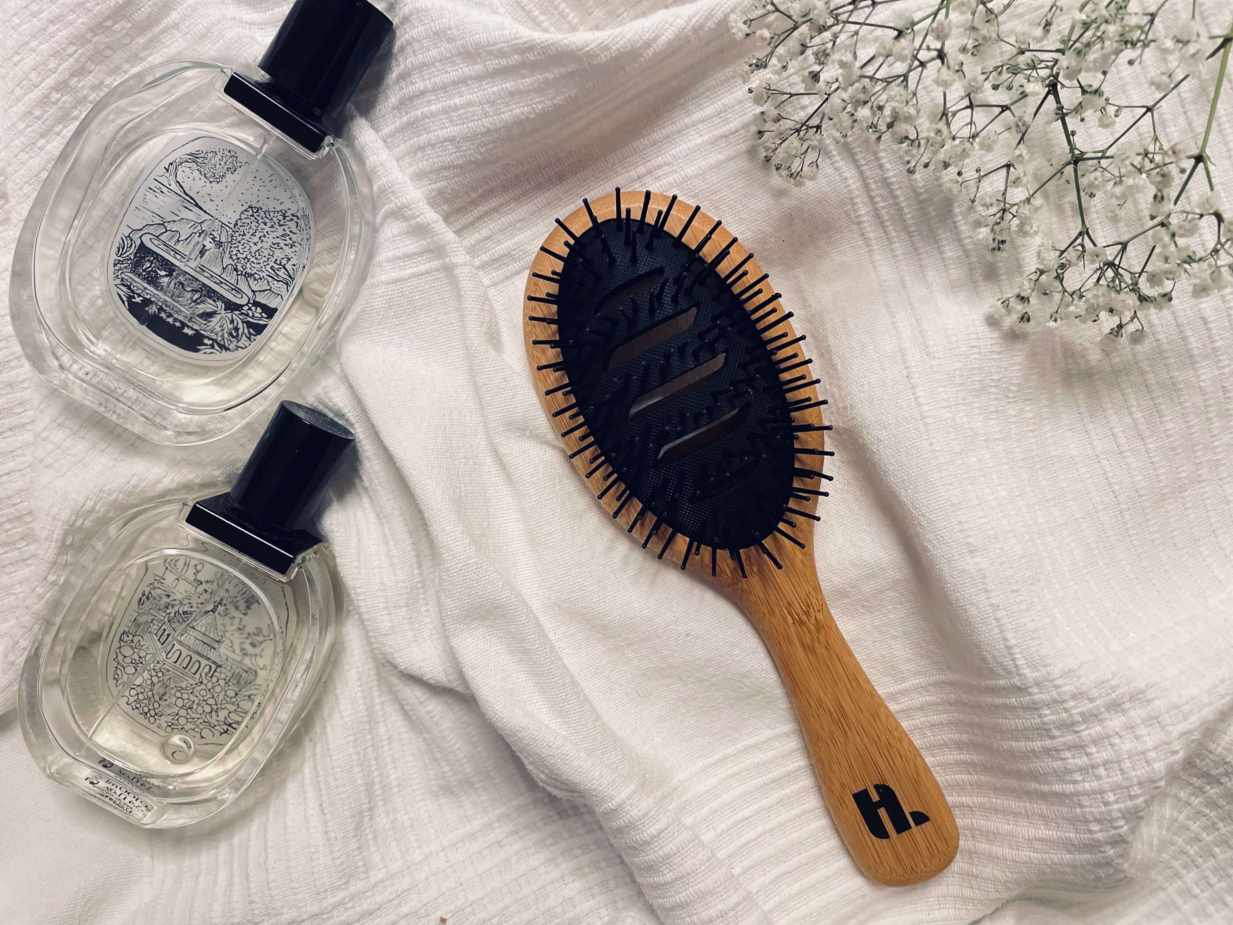 Hairlust Bamboo Vented Brush på en seng