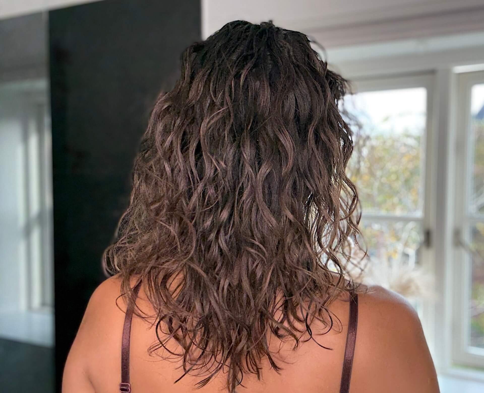 Krøllet hår på kvinde der har brugt IdHAIR Me Curl Cream