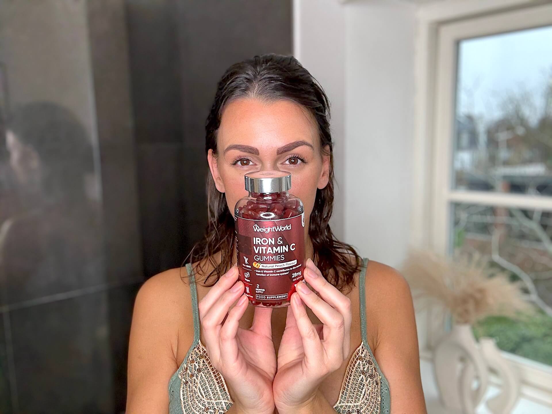 Kvinde der står med WeightWorld Iron & Vitamin C Gummies