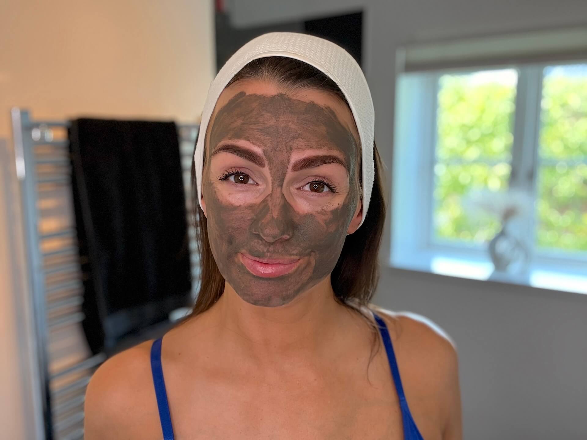 Kvinde med muddermaske på badeværelse fra Naturligolie