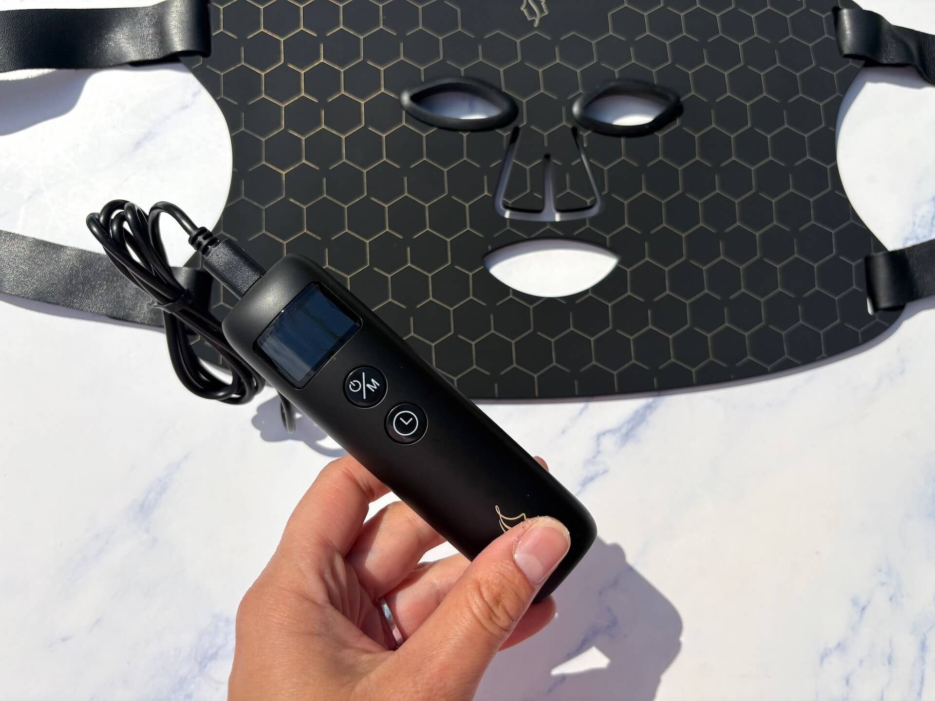 Slukket Comforth Light Pro led maske med fjernbetjening i hånd