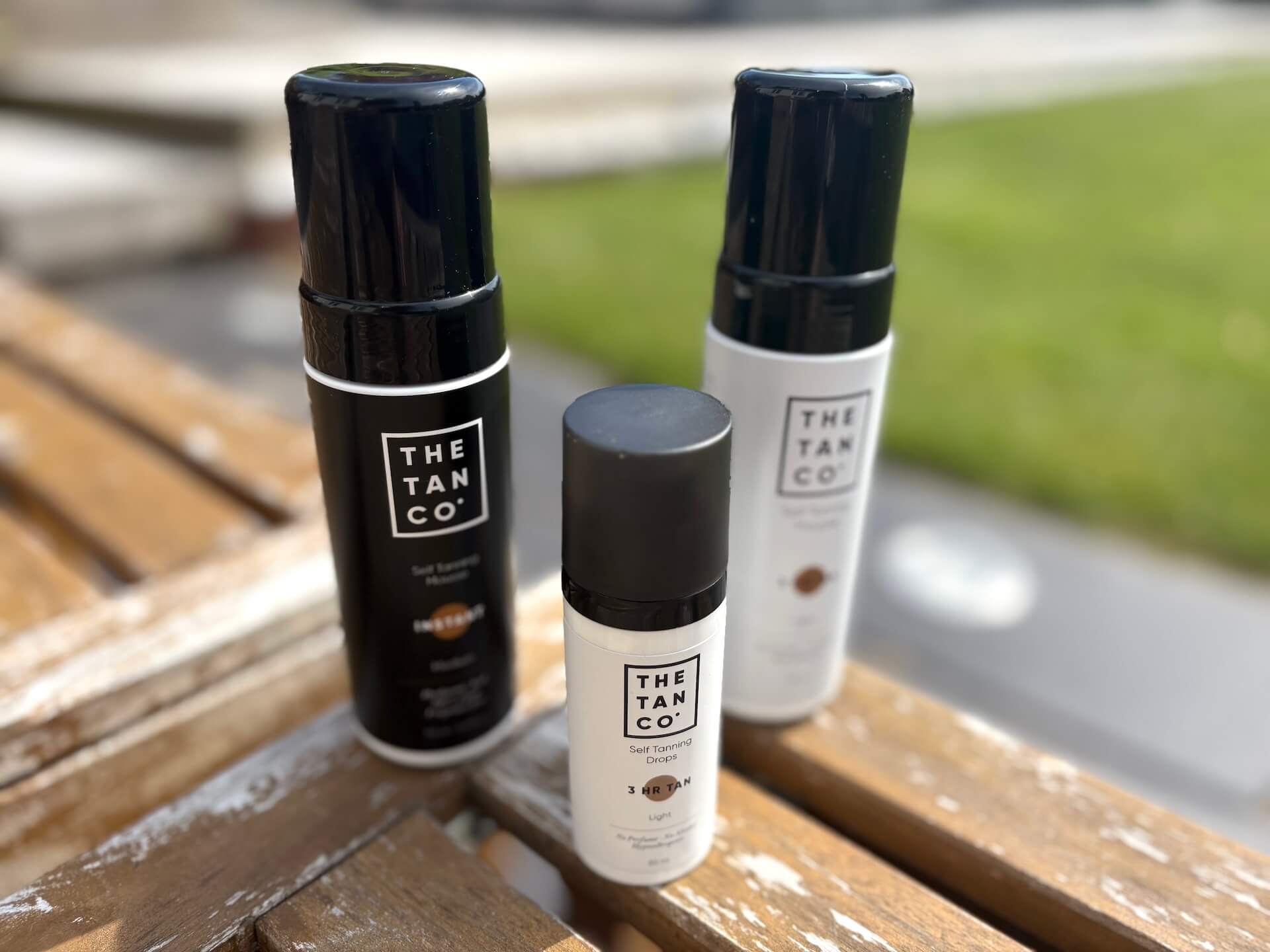 The Tan Co. 3 hr tan Light og medium samt dråber ved siden af hinanden udenfor