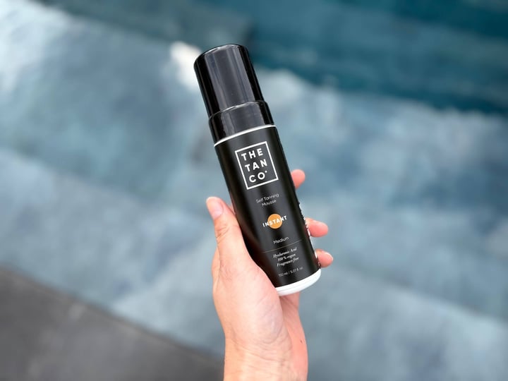 The Tan Co. Instant medium selvbruner mousser i hånd over pool