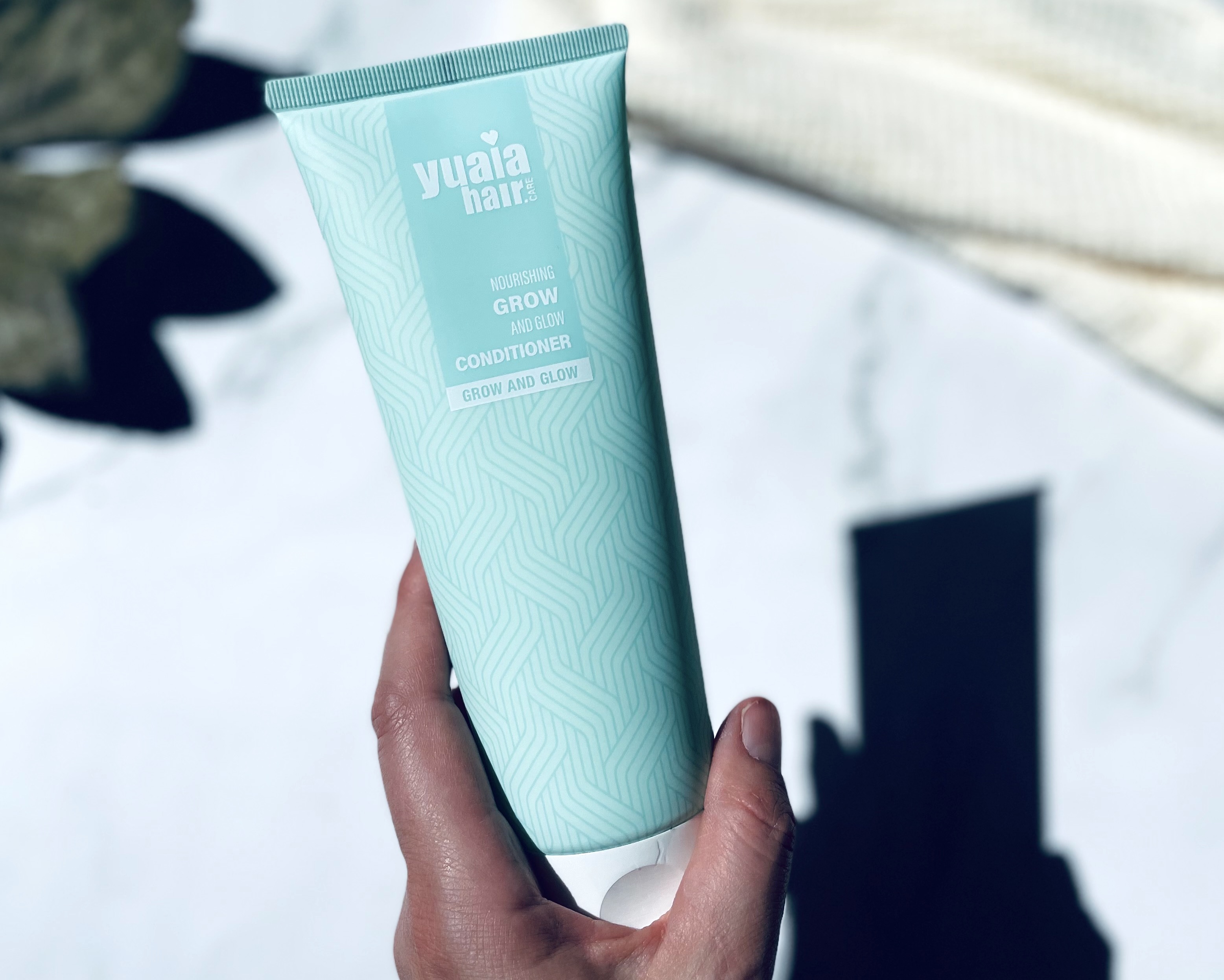 Yuaia Haircare Grow and Glow conditioner i hånd